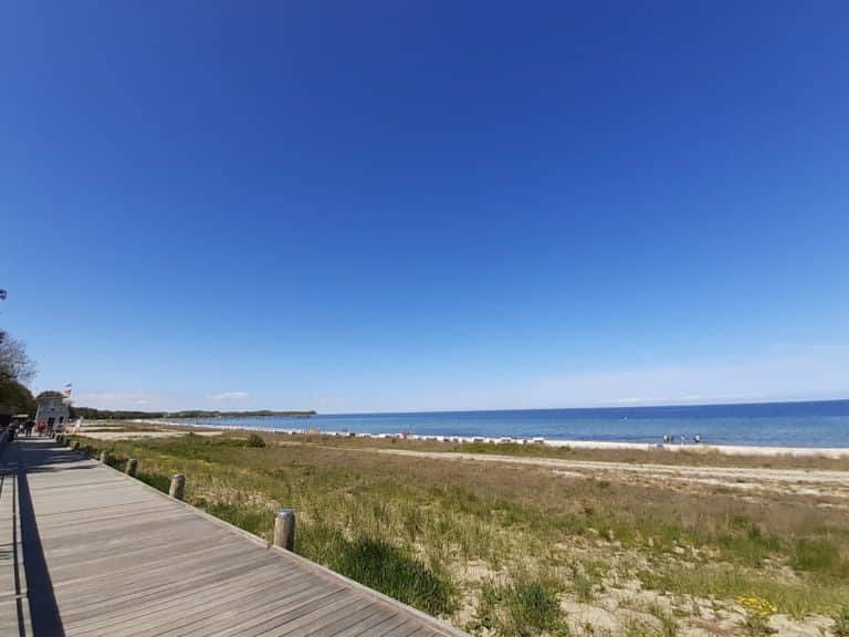 20220515_141223 (2) – Hubertus Boltenhagen Wooden jetty on a beach with blue sky and sea in the background.